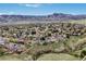 Expansive aerial view of neighborhood homes with beautiful mountain views in the distance on a sunny day at 2140 S Coors Cir, Lakewood, CO 80228