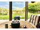 Covered patio with a round table, fire pit and comfortable seating; an inviting outdoor space with a manicured lawn at 2140 S Coors Cir, Lakewood, CO 80228