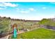 Spacious backyard with lush lawn, wooden playset, swing set, and a fenced perimeter, perfect for outdoor activities at 2140 S Coors Cir, Lakewood, CO 80228