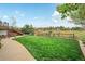 Large backyard with a green lawn, patio, playset, and a fence at 2140 S Coors Cir, Lakewood, CO 80228