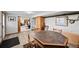 Finished basement with a dining area, featuring wood flooring, a classic table set, and natural light at 2140 S Coors Cir, Lakewood, CO 80228