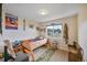 A cozy bedroom featuring a small bed, carpet flooring, and a view to the outdoors at 2140 S Coors Cir, Lakewood, CO 80228