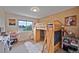 Bright bedroom with a unique loft bed, built-in storage, and a large window showcasing the outdoor view at 2140 S Coors Cir, Lakewood, CO 80228