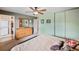 Bedroom with a wooden dresser, closet, ceiling fan, and a comfortable bed at 2140 S Coors Cir, Lakewood, CO 80228