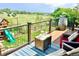Outdoor deck featuring a seating area, blue rug, and a playset in the background with gorgeous natural views at 2140 S Coors Cir, Lakewood, CO 80228