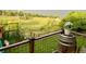 Outdoor deck features a barrel planter with flowers, dark metal fencing and natural views at 2140 S Coors Cir, Lakewood, CO 80228