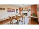 Cozy dining room with a rustic wooden table, chairs, and a fireplace at 2140 S Coors Cir, Lakewood, CO 80228