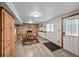 Basement dining area featuring a brick accent wall, wooden table set, and natural light at 2140 S Coors Cir, Lakewood, CO 80228
