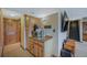 Hallway featuring a coffee bar, wood cabinets, and carpet flooring at 2140 S Coors Cir, Lakewood, CO 80228