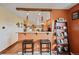 A bar featuring granite countertop open to a large kitchen at 2140 S Coors Cir, Lakewood, CO 80228