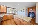 Kitchen island with light granite counter-top, wood floor and cabinets at 2140 S Coors Cir, Lakewood, CO 80228