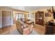 Cozy living room featuring neutral carpets, wood furniture, and ample natural light at 2140 S Coors Cir, Lakewood, CO 80228
