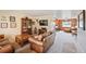 Inviting living room with a cozy atmosphere, neutral carpets, and a classic display cabinet at 2140 S Coors Cir, Lakewood, CO 80228