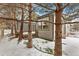 Backyard of home featuring mature trees and wooden deck at 2112 Springs Pl, Longmont, CO 80504