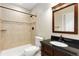 Elegant bathroom featuring a dark vanity and tiled shower at 2112 Springs Pl, Longmont, CO 80504