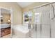 Bright bathroom featuring a soaking tub and glass-enclosed shower at 2112 Springs Pl, Longmont, CO 80504