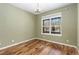 Bright bedroom with hardwood floors and a window overlooking the snow covered neighborhood at 2112 Springs Pl, Longmont, CO 80504