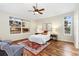 Inviting bedroom features hardwood floors, large windows, and a cozy rug at 2112 Springs Pl, Longmont, CO 80504