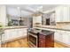 Bright kitchen with a cooktop island, granite countertops, stainless appliances, and hardwood floors at 2112 Springs Pl, Longmont, CO 80504