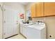 Functional laundry room featuring a washer, storage cabinets, and a convenient countertop at 2112 Springs Pl, Longmont, CO 80504