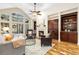 Spacious living room with a fireplace, built-in bookshelves, and a high ceiling, perfect for relaxing at 2112 Springs Pl, Longmont, CO 80504