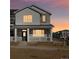 Two-story home with gray siding, stone accents, and a front porch at 6589 N Malaya St, Aurora, CO 80019