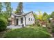 Scenic backyard featuring a lush lawn, manicured garden, and a detached structure with appealing architecture at 1016 S Cook St, Denver, CO 80209
