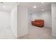 Finished basement area with light wood flooring and a comfortable leather couch at 1016 S Cook St, Denver, CO 80209