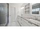 Elegant bathroom with double sink vanity, granite countertops, and a glass-enclosed shower at 1016 S Cook St, Denver, CO 80209