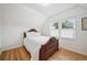 Cozy bedroom features hardwood floors, a decorative bed frame and large windows at 1016 S Cook St, Denver, CO 80209