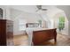 Cozy bedroom with hardwood floors, a ceiling fan, and an angled ceiling with natural light at 1016 S Cook St, Denver, CO 80209