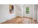Charming bedroom features hardwood floors, angled ceilings, and a window providing natural light at 1016 S Cook St, Denver, CO 80209