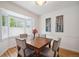 Bright dining room featuring a bay window, wooden table, and neutral-toned chairs for comfortable dining at 1016 S Cook St, Denver, CO 80209