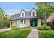 Charming two-story home with a well-maintained front yard, stone walkway, and inviting blue front door at 1016 S Cook St, Denver, CO 80209