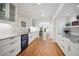 Stylish kitchenette with granite countertops, white cabinetry, and a wine fridge for added convenience at 1016 S Cook St, Denver, CO 80209