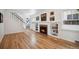 Bright living room with hardwood floors, a cozy fireplace, and custom built-in shelving for decor at 1016 S Cook St, Denver, CO 80209