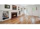 Elegant living room with hardwood floors, a brick fireplace, and beautiful natural light from a window at 1016 S Cook St, Denver, CO 80209
