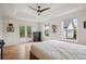 Bright main bedroom with hardwood floors, tray ceiling with ceiling fan, and patio access at 1016 S Cook St, Denver, CO 80209