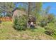 Backyard view of the home with a wooden privacy fence and mature trees at 3792 S Pitkin Ct, Aurora, CO 80013