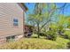 Side yard view of the multi-level deck, home's siding and well-maintained lawn at 3792 S Pitkin Ct, Aurora, CO 80013