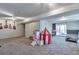 A large finished basement with carpet, sliding glass doors, and plenty of room to play at 3792 S Pitkin Ct, Aurora, CO 80013