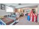 Spacious finished basement with neutral carpet, natural light, and a variety of recreational items at 3792 S Pitkin Ct, Aurora, CO 80013