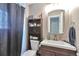 Cozy bathroom featuring dark fixtures, a single vanity, and patterned shower curtain at 3792 S Pitkin Ct, Aurora, CO 80013