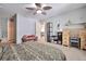 Bedroom featuring a cozy pink settee, ceiling fan and a organized work space at 3792 S Pitkin Ct, Aurora, CO 80013