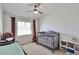 Bright Bedroom with crib, window, and neutral carpet at 3792 S Pitkin Ct, Aurora, CO 80013