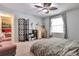 Light filled bedroom with a ceiling fan, window with curtains, and a unique workspace at 3792 S Pitkin Ct, Aurora, CO 80013