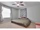 Bright bedroom with a ceiling fan, window with curtains, and a patterned bedspread at 3792 S Pitkin Ct, Aurora, CO 80013