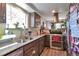Kitchen featuring stainless steel appliances, granite countertops, gray cabinets, and a view into an adjoining room at 3792 S Pitkin Ct, Aurora, CO 80013