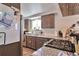 Galley kitchen features gray cabinets, granite countertops, stainless steel appliances, and a window over the sink at 3792 S Pitkin Ct, Aurora, CO 80013