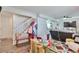 Cozy living room featuring a staircase, bench, and open layout with hardwood floors at 3792 S Pitkin Ct, Aurora, CO 80013